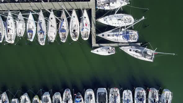 Drone Flies Over Sailboats In Bird's Eye View Wide Shot