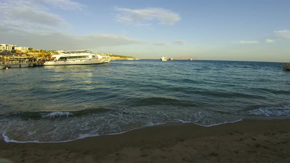 Pleasure Boats Arrive at the Port on the Beach in Egypt. Time Lapse