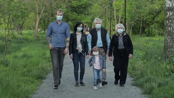 Large Family in Park Takes Off Medical Masks After Coronavirus Quarantine End