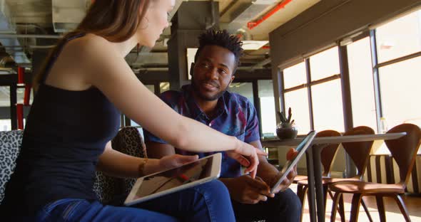 Side view of young cool mixed-race business team planning and sitting on couch of modern office 4k