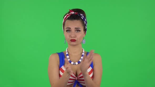 Portrait of Beautifulgirl in a Swimsuit Is Clapping Her Hands Indifferent. Green Screen