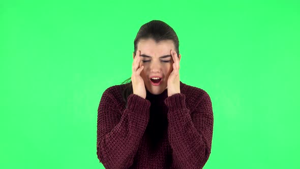 Woman Suffering From Headache From Fatigue. Green Screen