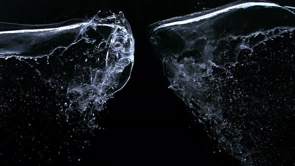 Super Slow Motion Shot of Water Splashes Crashing on Black Background at 1000Fps alt