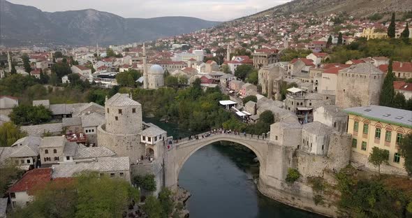 Aerial shot of Stari Most, old bridge, in Mostar. the camera slowly pushes in and passes over Stari