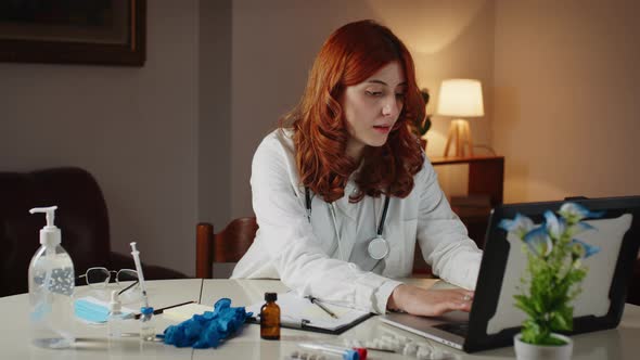 Young Beautiful Italian Female Doctor Writes the Prescription on the Laptop