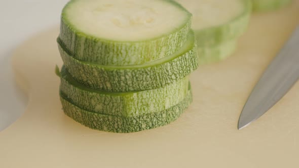 Slices of organic zucchini on pile close-up 4K 2160p 30fps UltraHD tilting  footage - Sliced Pepo cy