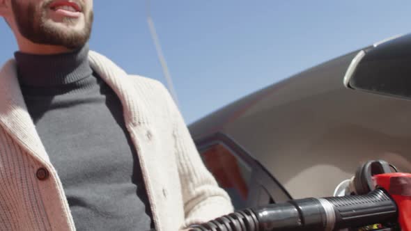 Man Paying at Gas Station