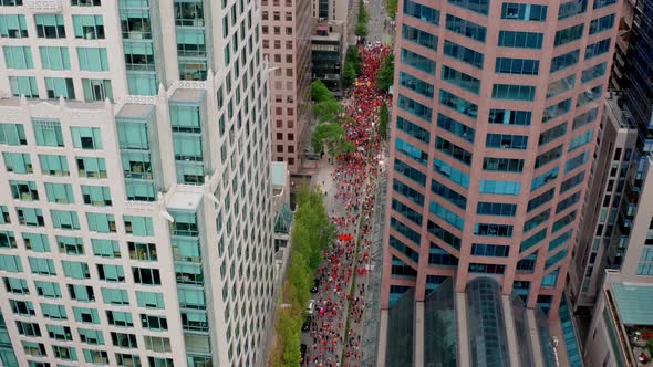 People in Orange Shirts fill the Street to Protest, High Drone Shot Moving Forward