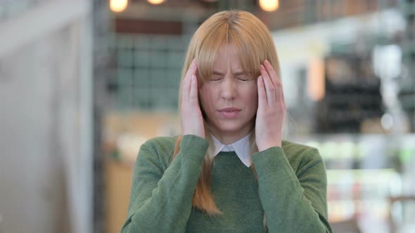 Portrait of Young Woman Having Headache