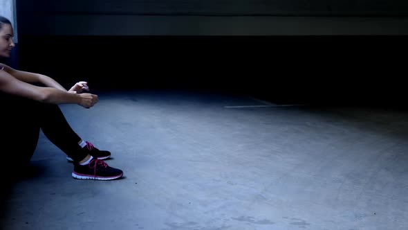 Woman taking break in underground parking area 4k