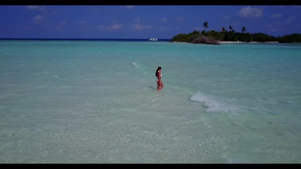 Lady posing on idyllic lagoon beach vacation by blue water and bright sand background of the Maldive