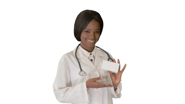 Woman Doctor Smiling and Holding a Box of Medication On