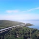 beautiful expressway in a green forest with a dam on the side of the road between mountains. - VideoHive Item for Sale