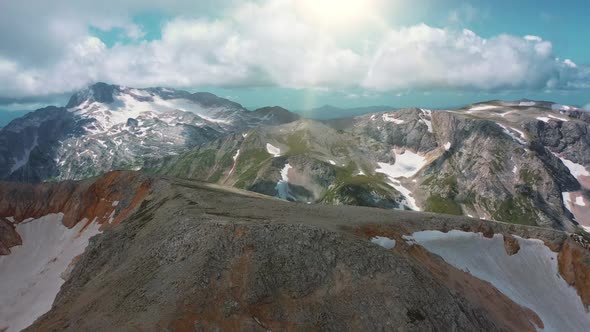 Top View of Stunning Landscape of Beautiful Caucasian Mountains Under Sunrays Shining From Clouds