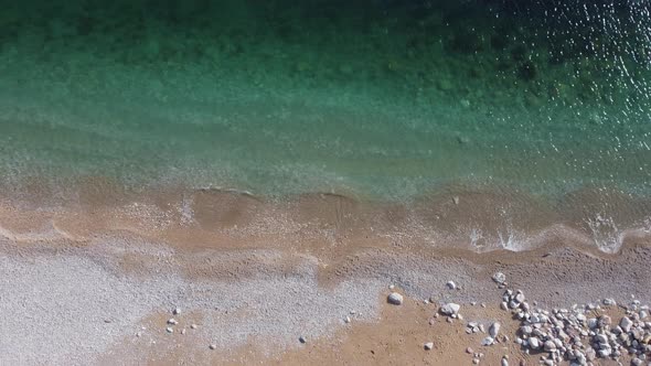 Aerial View From Above on Azure Sea and Pink Pebbles Beach