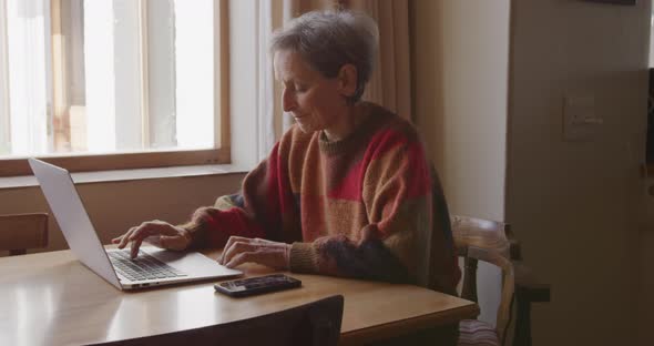 Senior woman relaxing alone at home