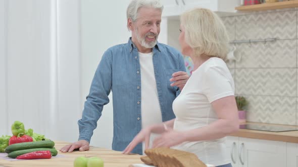 Old Couple Working on Smartphone in Kitchen