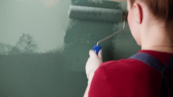 Renovation Painting Walls with Blue Paint Using Brush Closeup