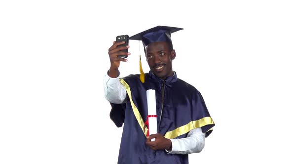 Student Takes a Photo with a Diploma. Slow Motion. White