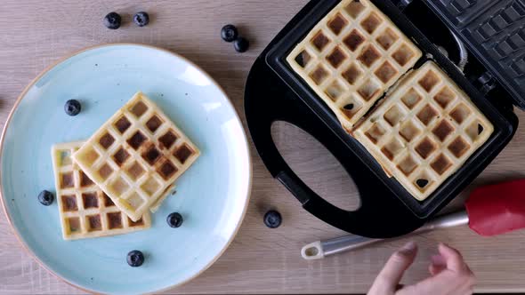 Waffles Being Baked in the Waffle Maker. Savory waffles. Breakfast concept.