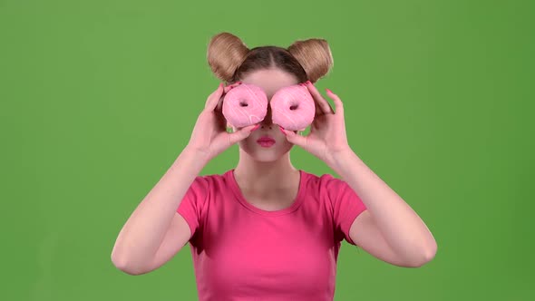 Teen Holds Cake in Her Hands and Closes Her Eyes. Green Screen