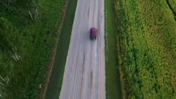 The car is moving on a rural road