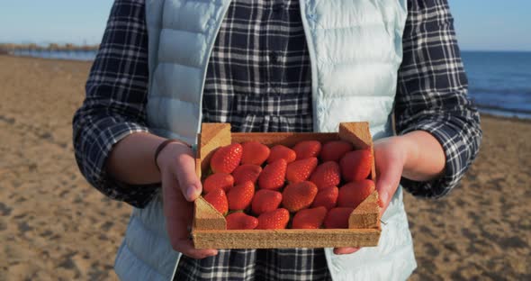 Female Hands Holding Wooden Box Full of Ripe Straberry