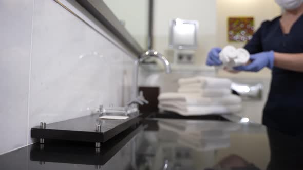 Hotel Employee Putting Clear Hand Towels Near Tap