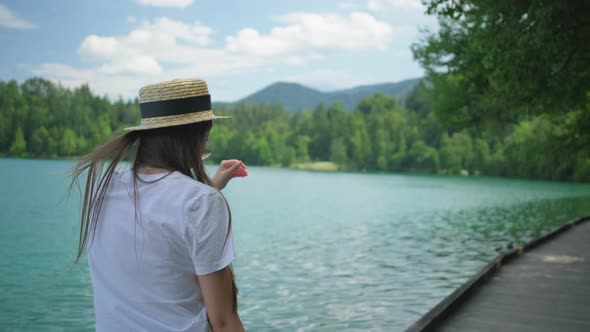 Woman is Walking on Path of Shore of Lake in Summer Day