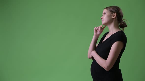 Profile View of Young Pregnant Businesswoman Thinking