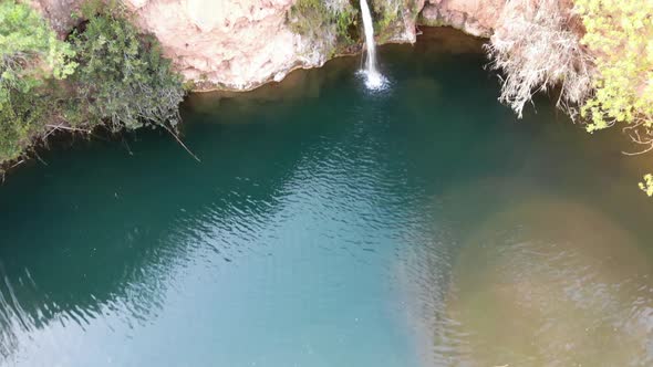 Reveal of Pego do Inferno waterfall in Santo Estevao, Algarve. Aerial tilt up 