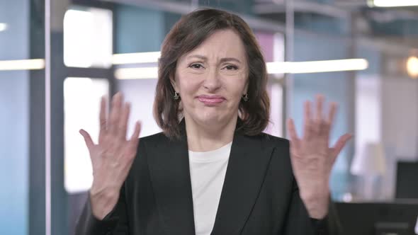 Portrait of Shocked Middle Aged Businesswoman Reacting To Failure By Hand Gesture