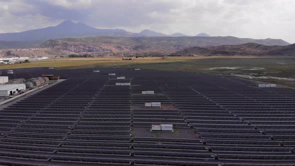Aerial Shot of a Huge Solar Power Plant in a Big Field. Electricity Generation From Solar Energy alt