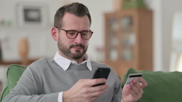 Middle Aged Man Making Online Payment on Smartphone