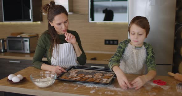 Mother and Her Little Toddler Baby Boy Son Spread Cookies on a Baking Sheet