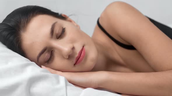 Face of Adorable Fashion Woman with Beauty Makeup Sleeping on Bed