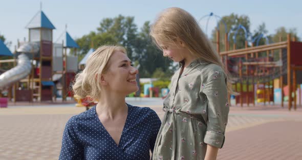 Portrait of Caucasian Mother and Toddler Girl Child Having Fun Together at Playground