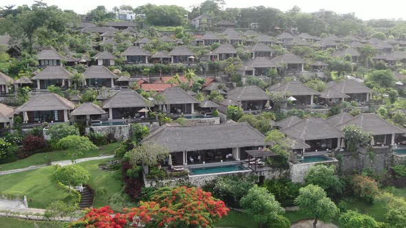 Flight of a Drone Over a Village on the Seashore