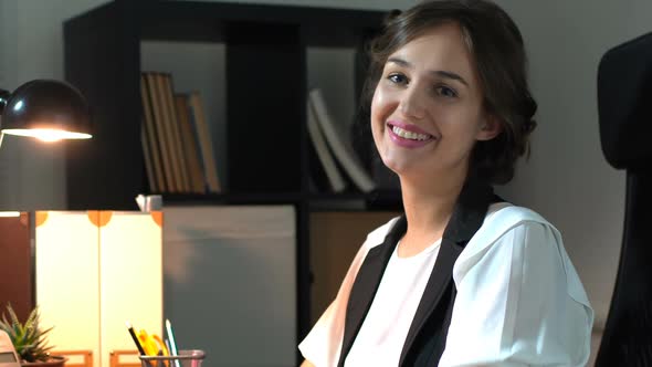 Businesswoman Sitting At Her Workplace In Office