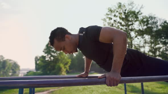 Muscular Afro Man Exercising on Outdoor Sport Equipment