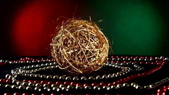 Unusual Gold Toy for Christmas or New Year and Beads, Rotation, on Red and Green