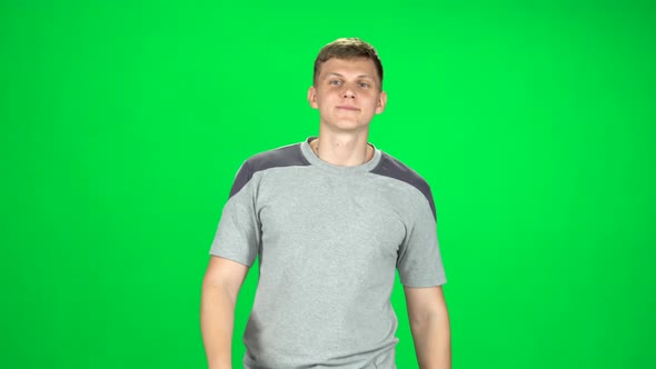 Young Man Walking and Greeting on a Green Screen, Chroma Key
