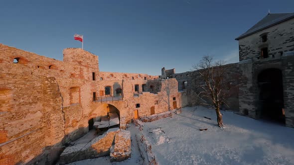 Aerial View of Beautiful Historic Castle Ruins on the Hill in Winter at Sunset