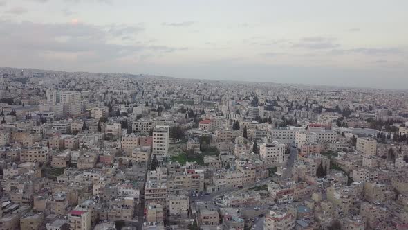 Serene early morning in Amman Jordan  taken by a drone slowly descending and moving with a flock of