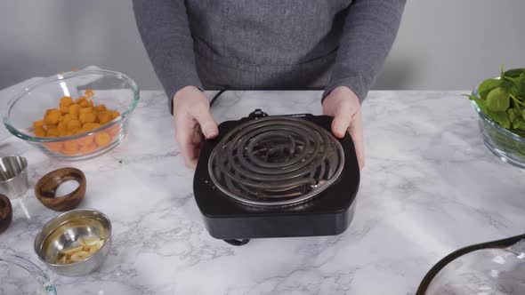 Cooking vegetarian white bean soup in cast iron dutch oven