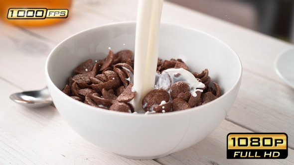 Pouring Milk into Bowl with Cocoa Shell-Shaped Cereals