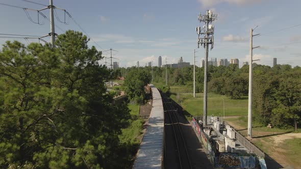 Aerial view of cargo train heading towards de city of Houston, Texas, USA.
