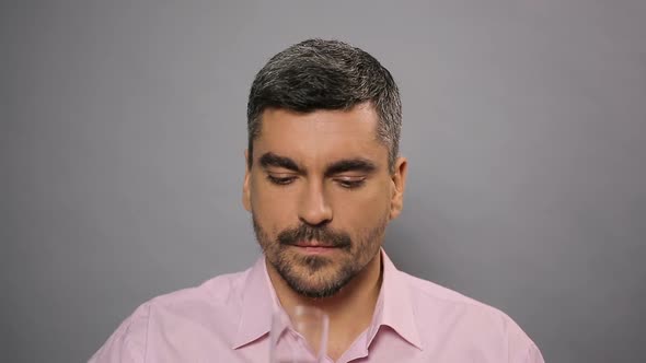 Confident Male Sitting at Conference and Drinking Mineral Water From Glass