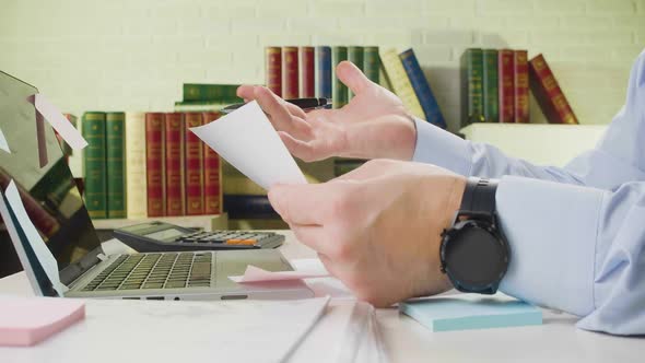 Hands Closeup Man Checking Tax Forms Documents and Reports Finds a Critical Error Crumples the Paper