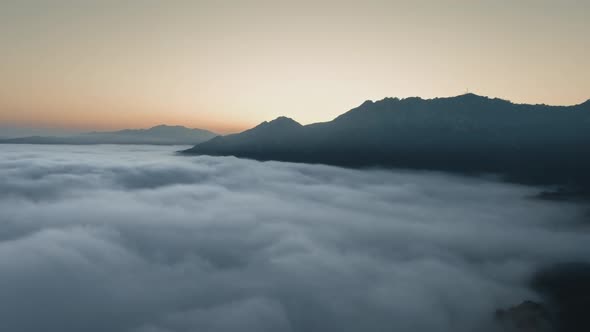 Clouds and the sun hides behind the mountain at sunset in Malibu Canyon, Calabasas, California, USA